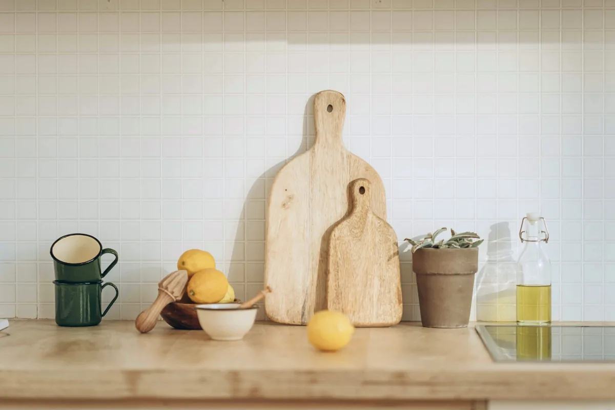Kitchen counter with cutting boards, lemons, and oil bottle