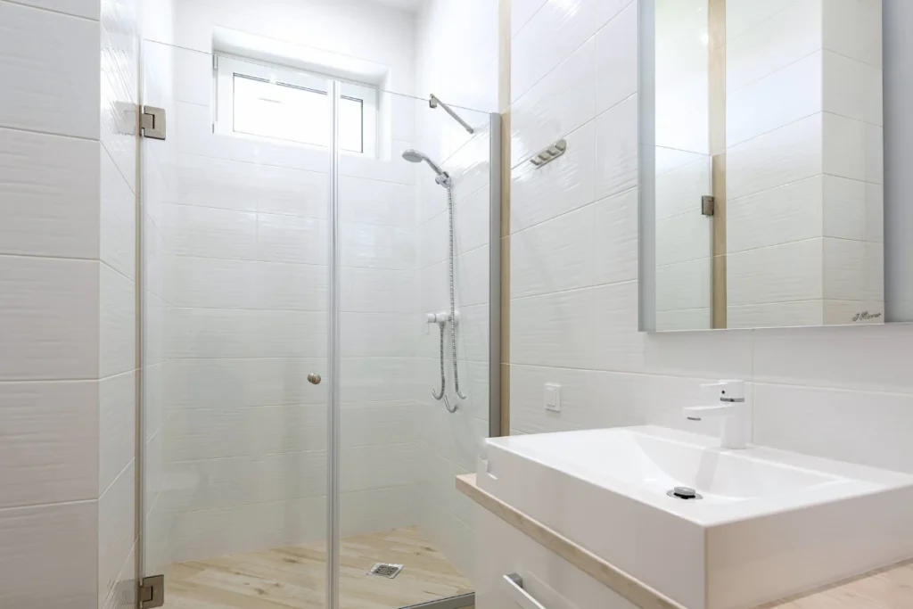 bright clean bathroom shower with natural light and glass door