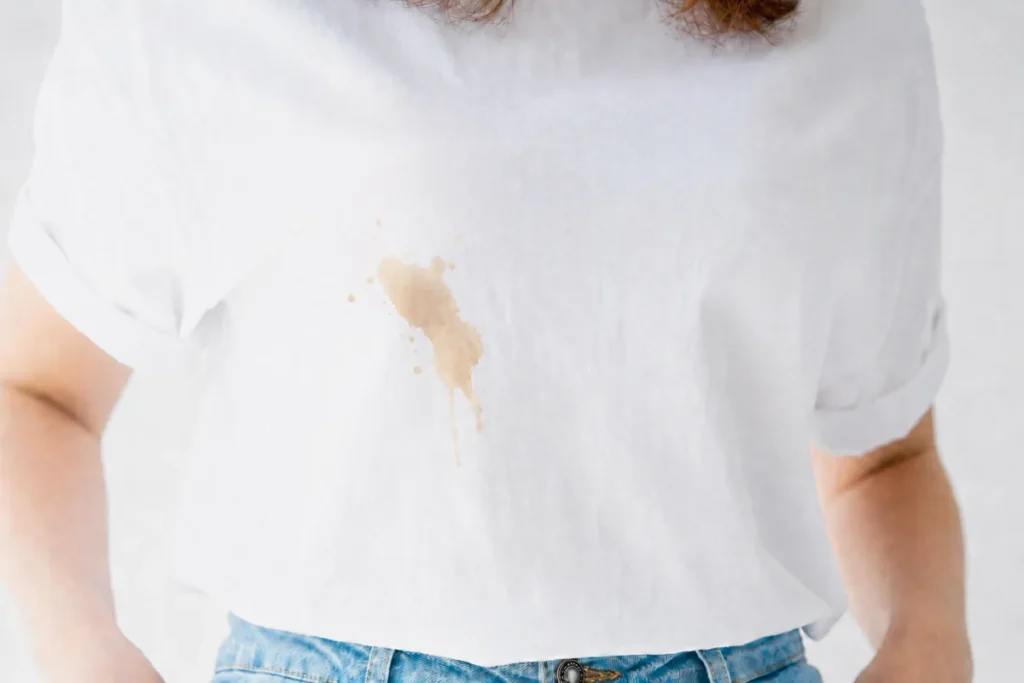 Light coffee stain on a white shirt close-up before stain removal
