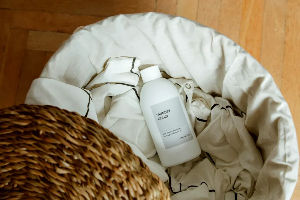 Laundry stain remover bottle in a basket of clothes